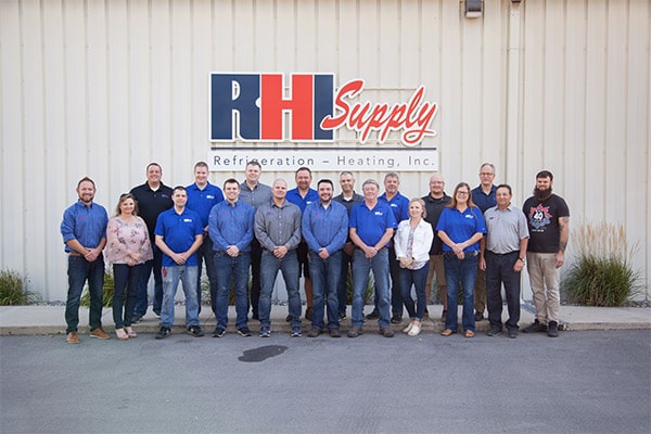 RHI Supply team standing near RHI Supply building.